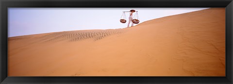 Framed Low angle view of a woman carrying panniers, Mui Ne, Vietnam Print