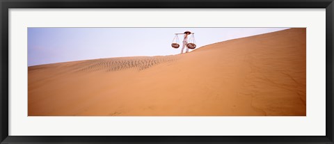 Framed Low angle view of a woman carrying panniers, Mui Ne, Vietnam Print