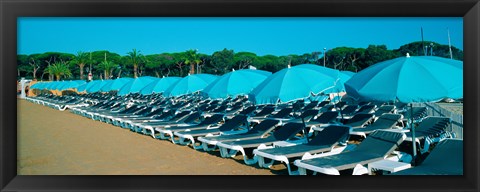 Framed Parasols with lounge chairs on a private beach in summer morning light, French Riviera, France Print