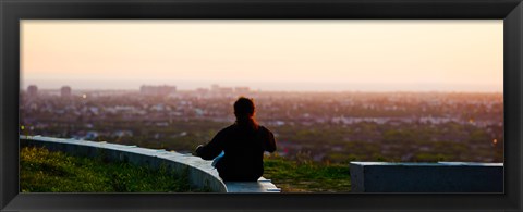 Framed Man sting on the ledge in Baldwin Hills Scenic Overlook Park, Culver City, Los Angeles County, California, USA Print