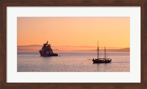 Framed Tugboat and a tall ship in the Baie de Douarnenez at sunrise, Finistere, Brittany, France Print