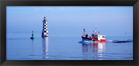 Framed Les Perdrix lighthouse and fishing boat at Loctudy, Brittany, France Print