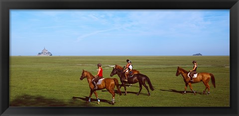 Framed Horseback riders in a field with Mont Saint-Michel island in background, Manche, Basse-Normandy, France Print