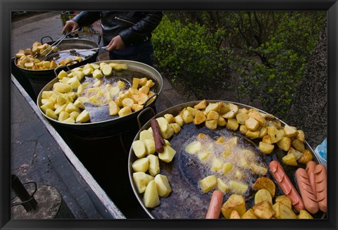 Framed Vendor selling deep fried potatoes and sausages at a sidewalk food stall, Old Town, Dali, Yunnan Province, China Print