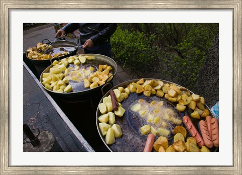 Framed Vendor selling deep fried potatoes and sausages at a sidewalk food stall, Old Town, Dali, Yunnan Province, China Print