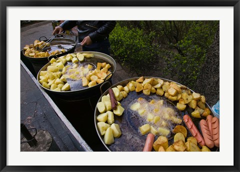 Framed Vendor selling deep fried potatoes and sausages at a sidewalk food stall, Old Town, Dali, Yunnan Province, China Print