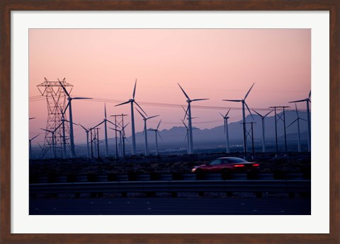 Framed Car moving on a road with wind turbines in background at dusk, Palm Springs, Riverside County, California, USA Print