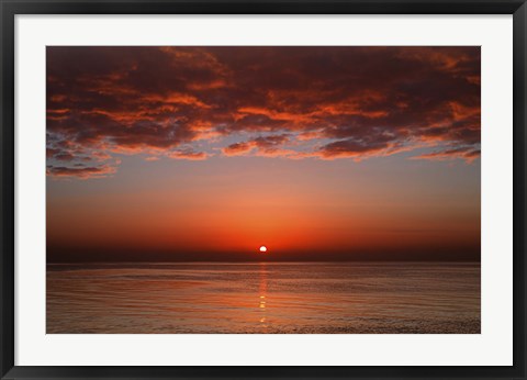 Framed layer of clouds is lit by the rising sun over Rio de la Plata, Buenos Aires, Argentina Print