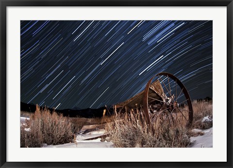 Framed Abandoned farm equipment against a backdrop of star trails Print