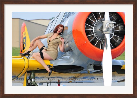 Framed 1940&#39;s style pin-up girl posing on a T-6 aircraft Print