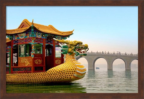 Framed Summer Palace, a traditional Dragon Boat passes the Seventeen Arch Bridge, Kunming lake, Beijing, China Print