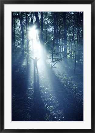 Framed Silhouette of a man standing in the misty rays of a dark forest, Denmark Print