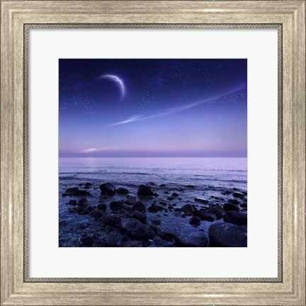 Framed Moon rising over rocky seaside against starry sky Print