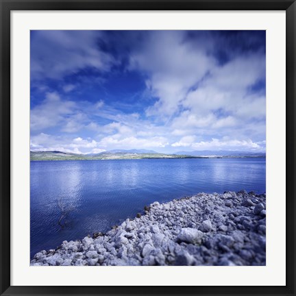 Framed Tranquil lake and rocky shore against cloudy sky, Sardinia, Italy Print