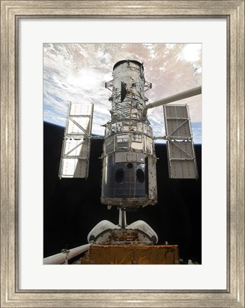 Framed Space Shuttle Atlantis&#39; arm lifts the Hubble Space Telescope from the cargo bay Print