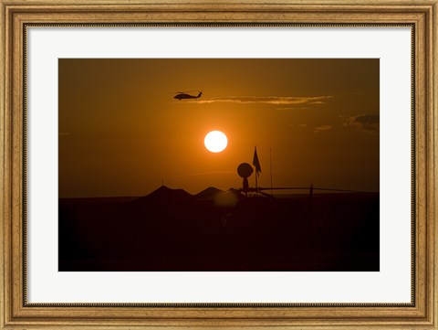 Framed UH-60 Blackhawk Flies Over Camp Speicher Airfield at Sunset Print