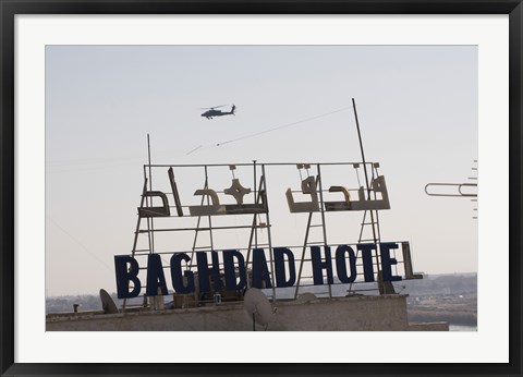 Framed AH-64 Apache in flight over the Baghdad Hotel in central Baghdad, Iraq Print