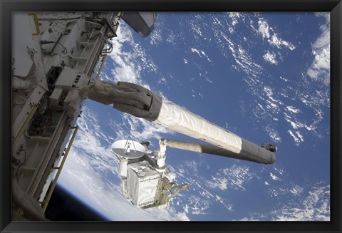 Framed Integrated Cargo Carrier in the grasp of the shuttle&#39;s remote manipulator system arm Print