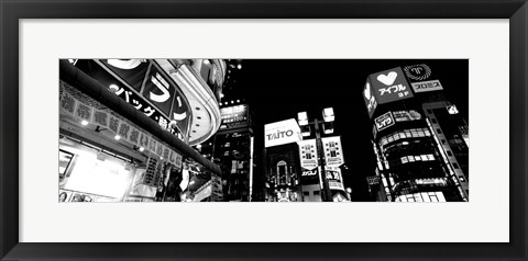 Framed Low angle view of buildings lit up at night, Tokyo, Japan Print