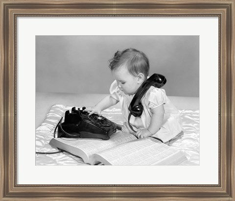 Framed 1960s Baby Girl With Telephone Book Print