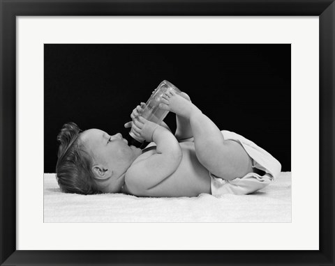 Framed 1950s Baby Lying On Back Drinking From Bottle Print