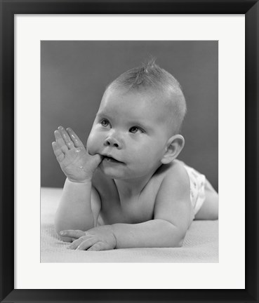 Framed 1950s Baby Lying On Stomach With Thumb In Mouth Print