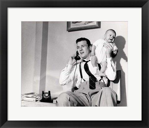 Framed 1950s Father Holding Baby While On The Phone Print